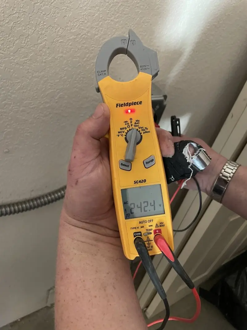 Voltage testing with clamp meter during Outlet Installation in Grants